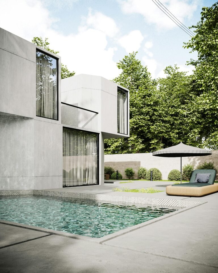 Minimalist concrete house with pool and garden, showcasing modern architecture.